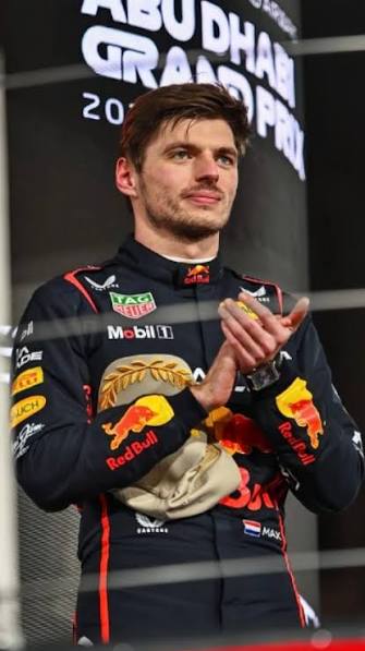 Max Verstappen on the grid at the 2025 Abu Dhabi Grand Prix under the Yas Marina floodlights